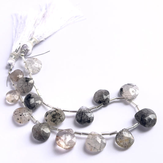 Stone beads in a strand of Black Rutile, highlighting their polished facets and 9.5–12.7mm size.
