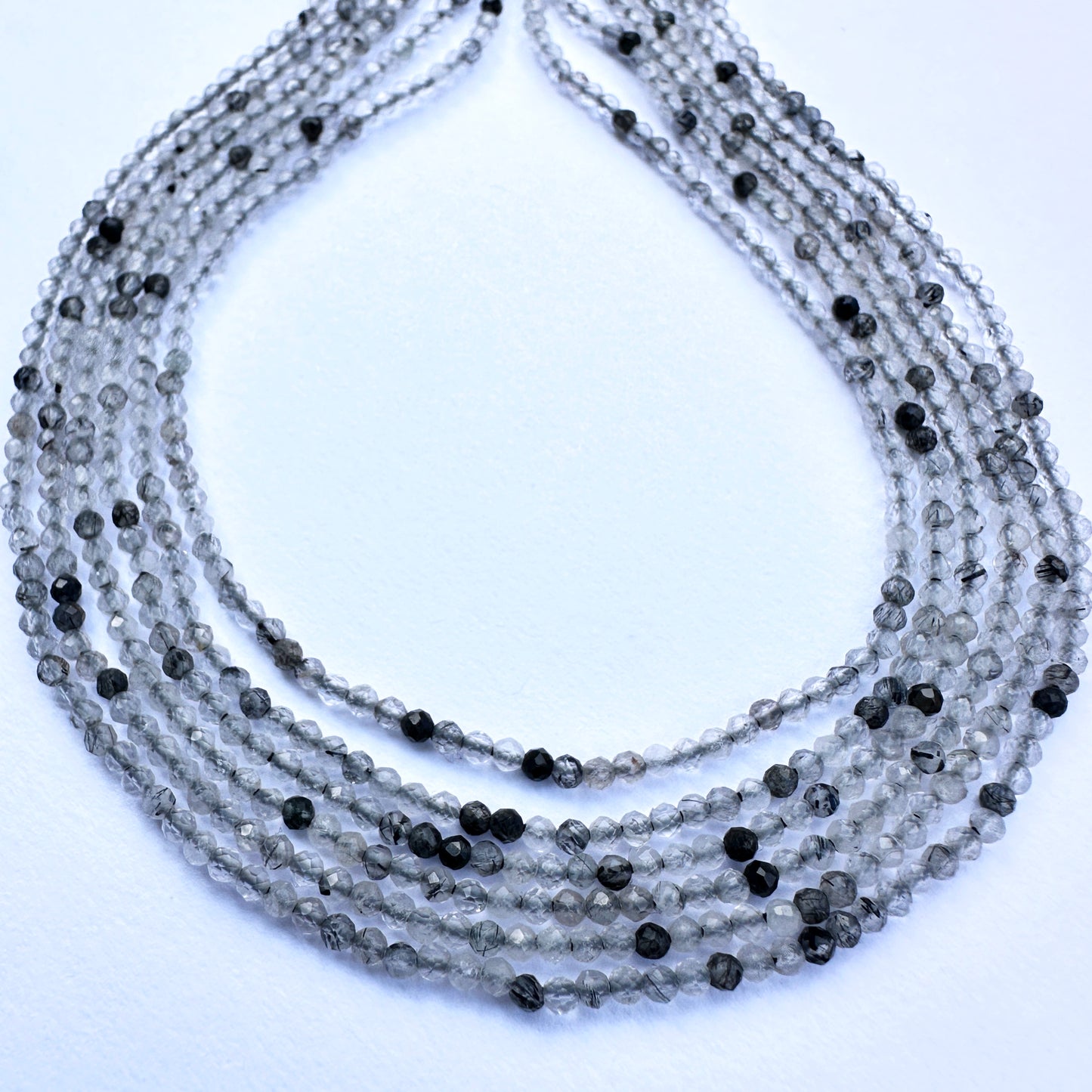 Black rutile micro faceted rondelle beads in 2mm size with shimmering finish, ideal for handmade jewellery components.