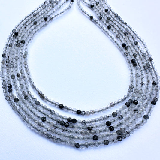 Black rutile micro faceted rondelle beads in 2mm size with shimmering finish, ideal for handmade jewellery components.