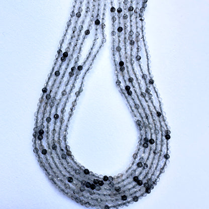 Stone beads for DIY jewellery featuring micro faceted rondelle cut and subtle dark inclusions for unique texture