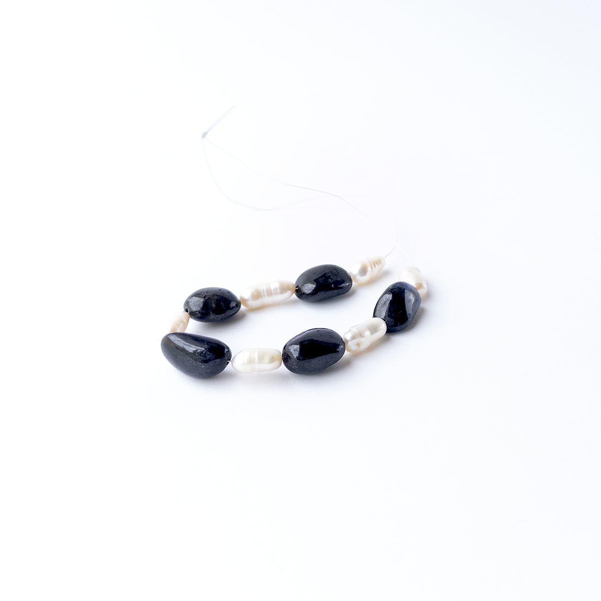 Black Sapphire and Freshwater Pearl gemstone beads featuring a striking contrast of deep dark tones and radiant pearl lustre.