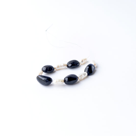 Black Sapphire and Freshwater Pearl gemstone beads featuring a striking contrast of deep dark tones and radiant pearl lustre.
