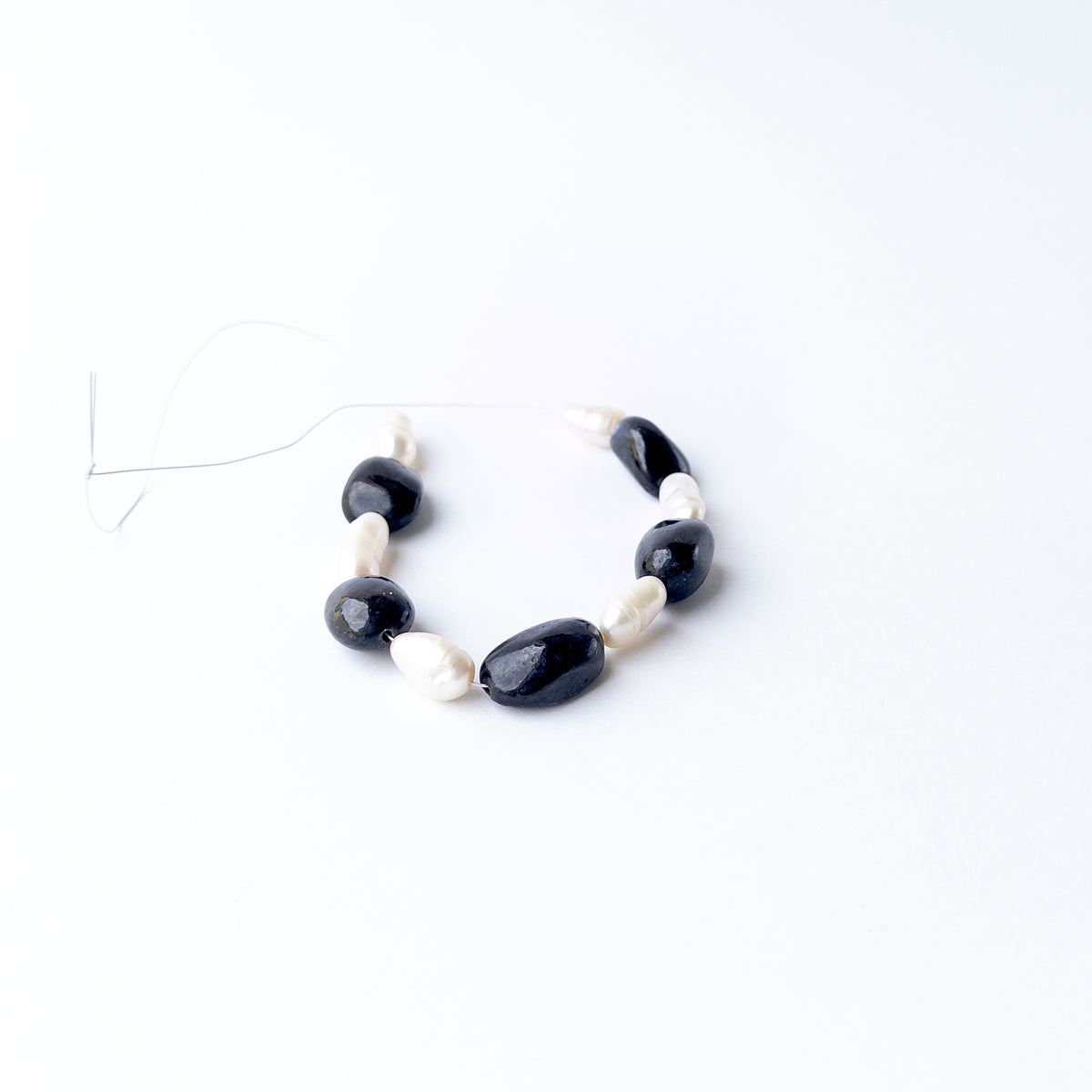 Genuine gemstone beads combining polished Black Sapphire with luminous Freshwater Pearls in a premium bead selection.