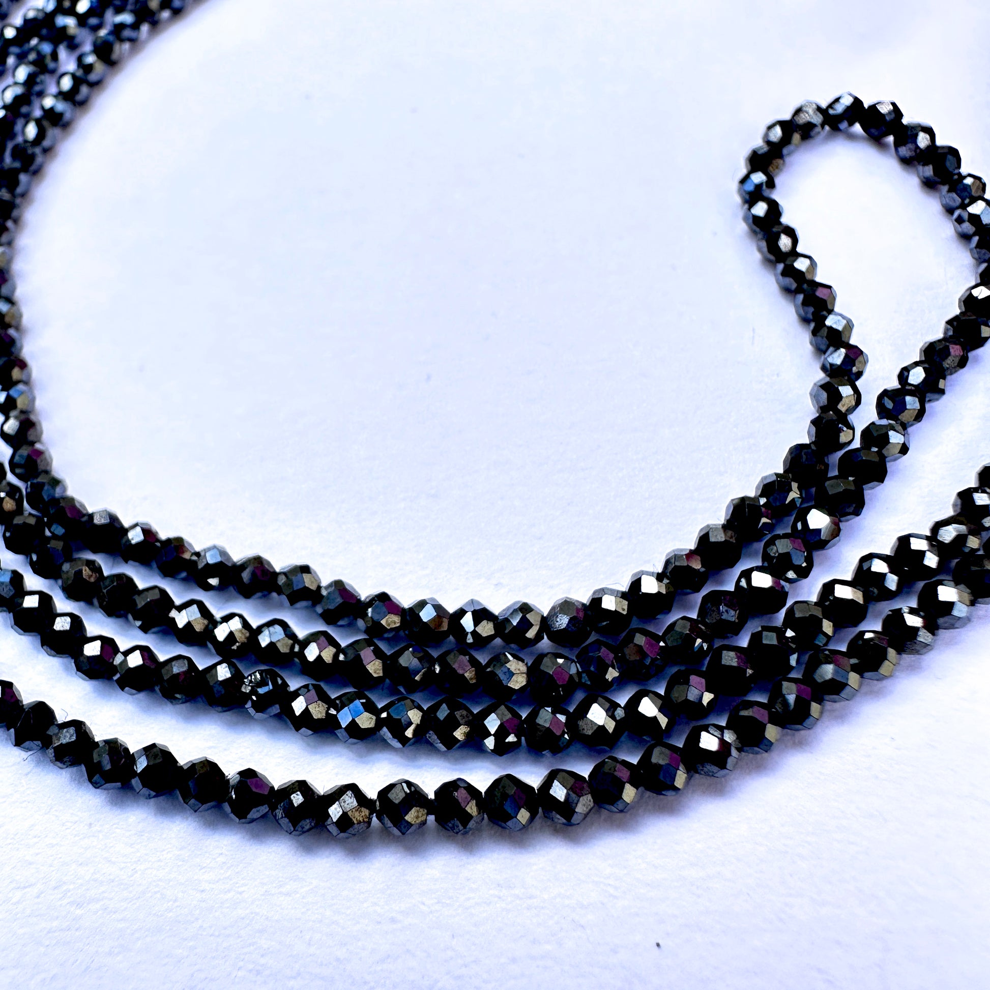 A dial gauge measures the Black Spinel faceted rondelle 2.1mm gemstone.