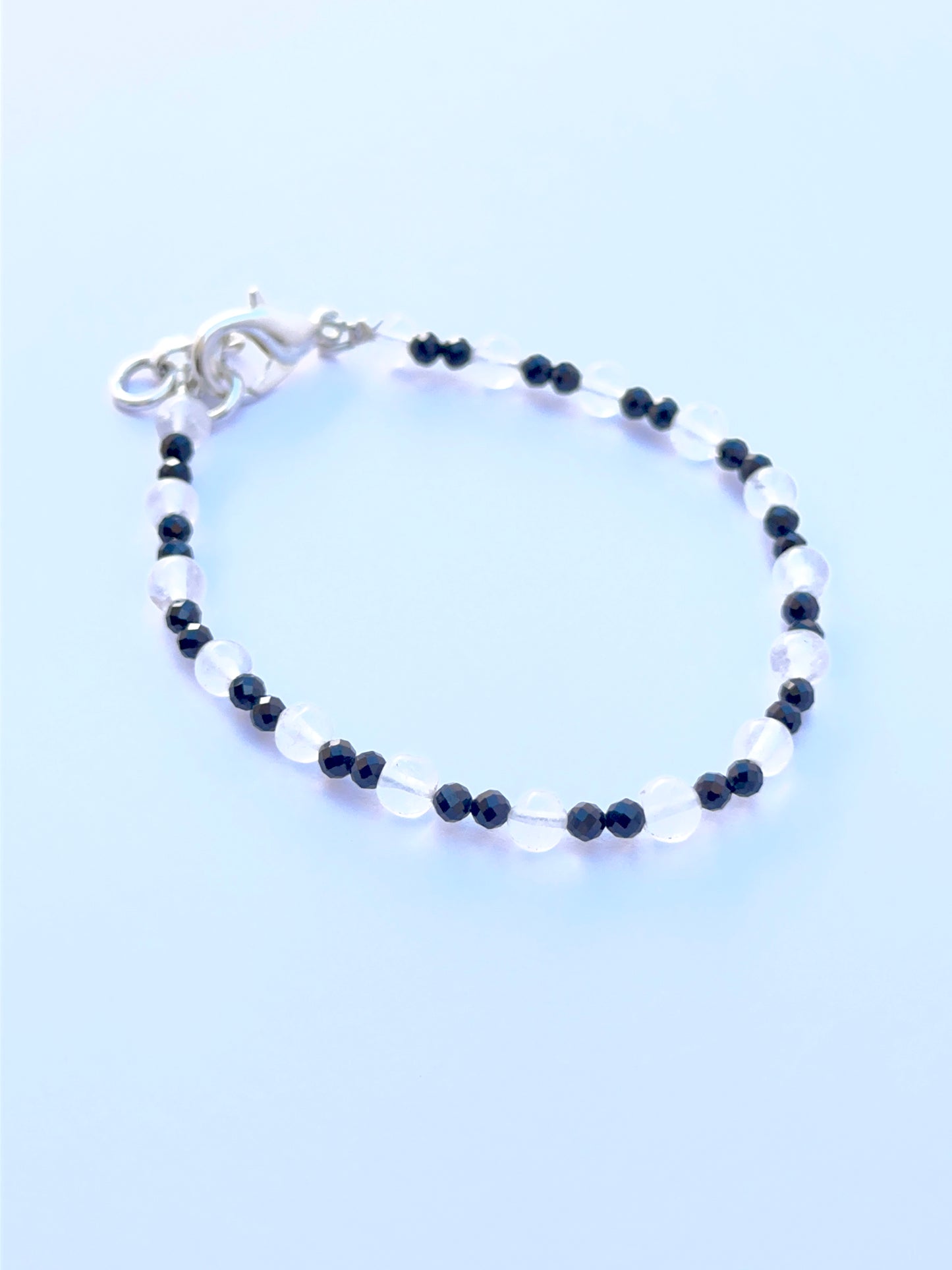 Smooth round black spinel and crystal beads displayed with glossy surfaces ideal for handmade jewellery.