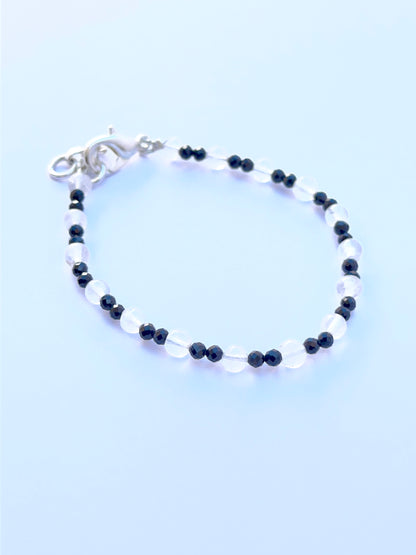 Smooth round black spinel and crystal beads displayed with glossy surfaces ideal for handmade jewellery.