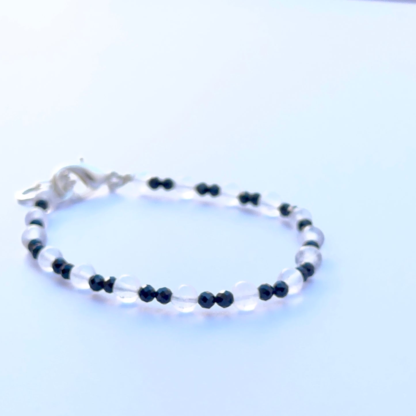 Close‑up of black spinel and crystal beads highlighting their polished finish and bright reflective sparkle.