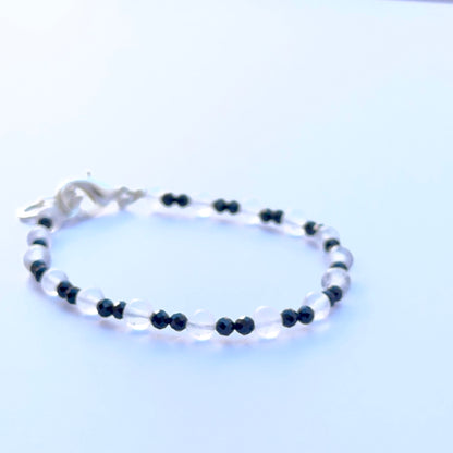Close‑up of black spinel and crystal beads highlighting their polished finish and bright reflective sparkle.