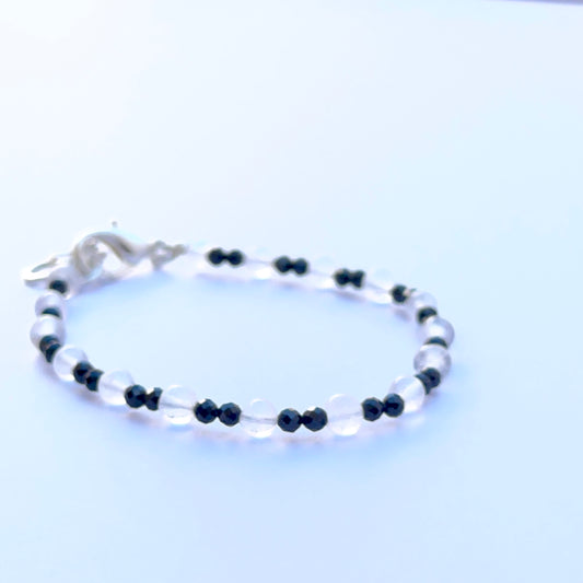 Close‑up of black spinel and crystal beads highlighting their polished finish and bright reflective sparkle.