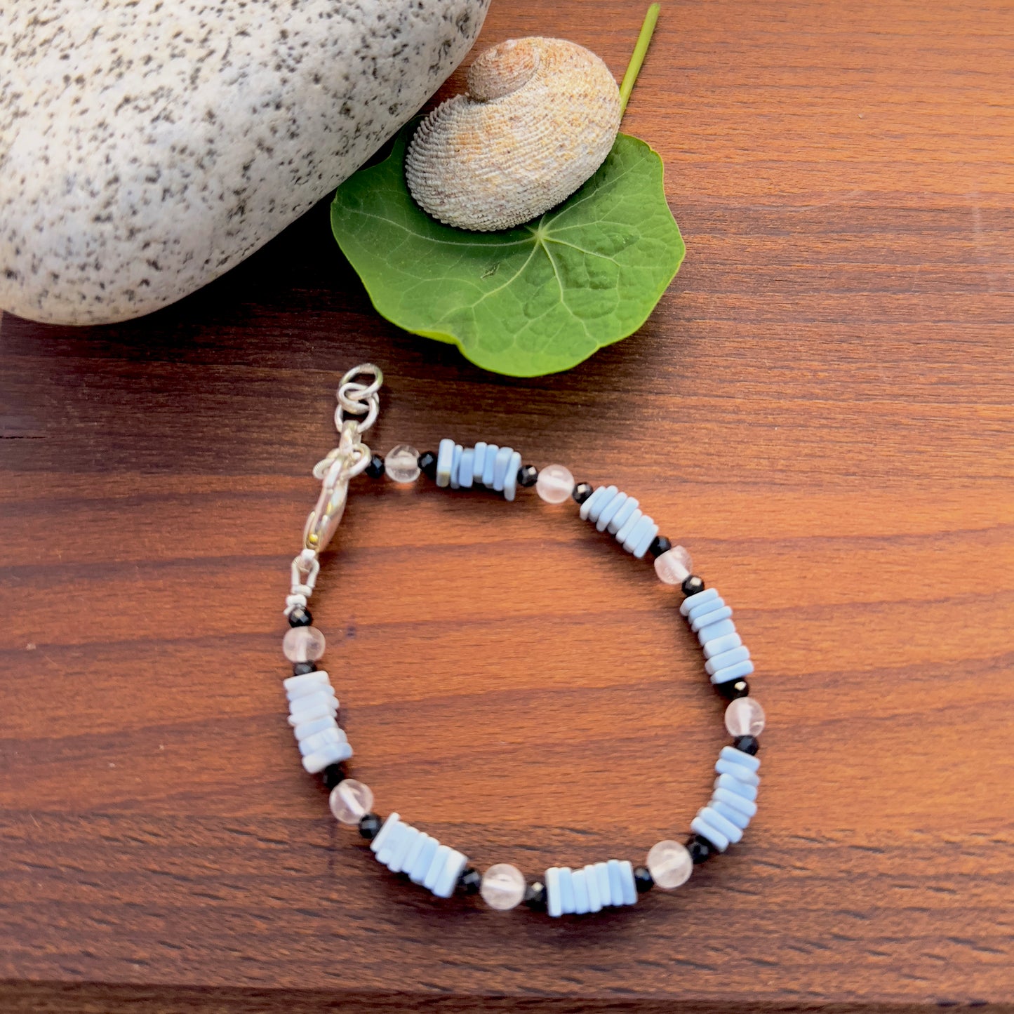 Black spinel, crystal and denim opal bracelet with 5mm beads and adjustable lobster clasp.
