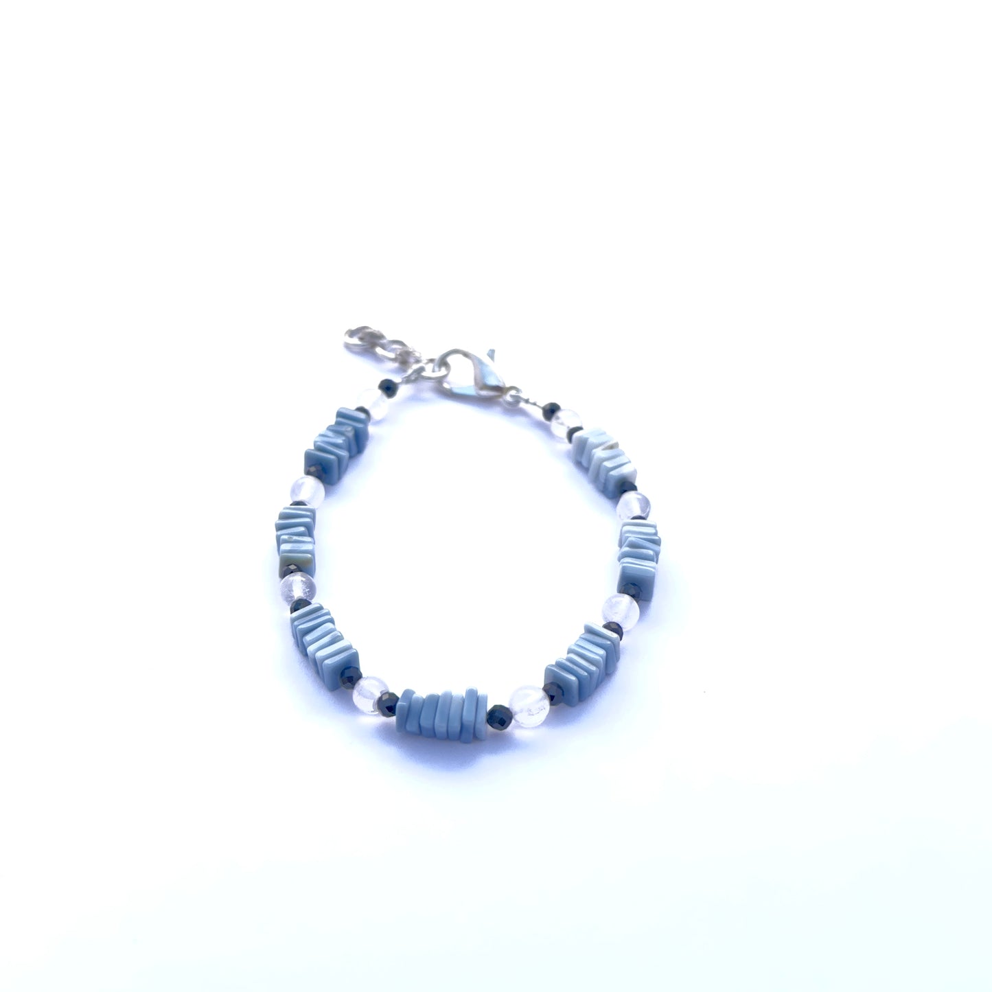 Close-up of faceted black spinel and smooth denim opal beads in a stylish bracelet.