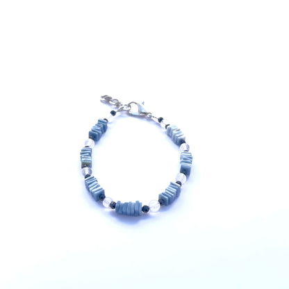 Close-up of faceted black spinel and smooth denim opal beads in a stylish bracelet.