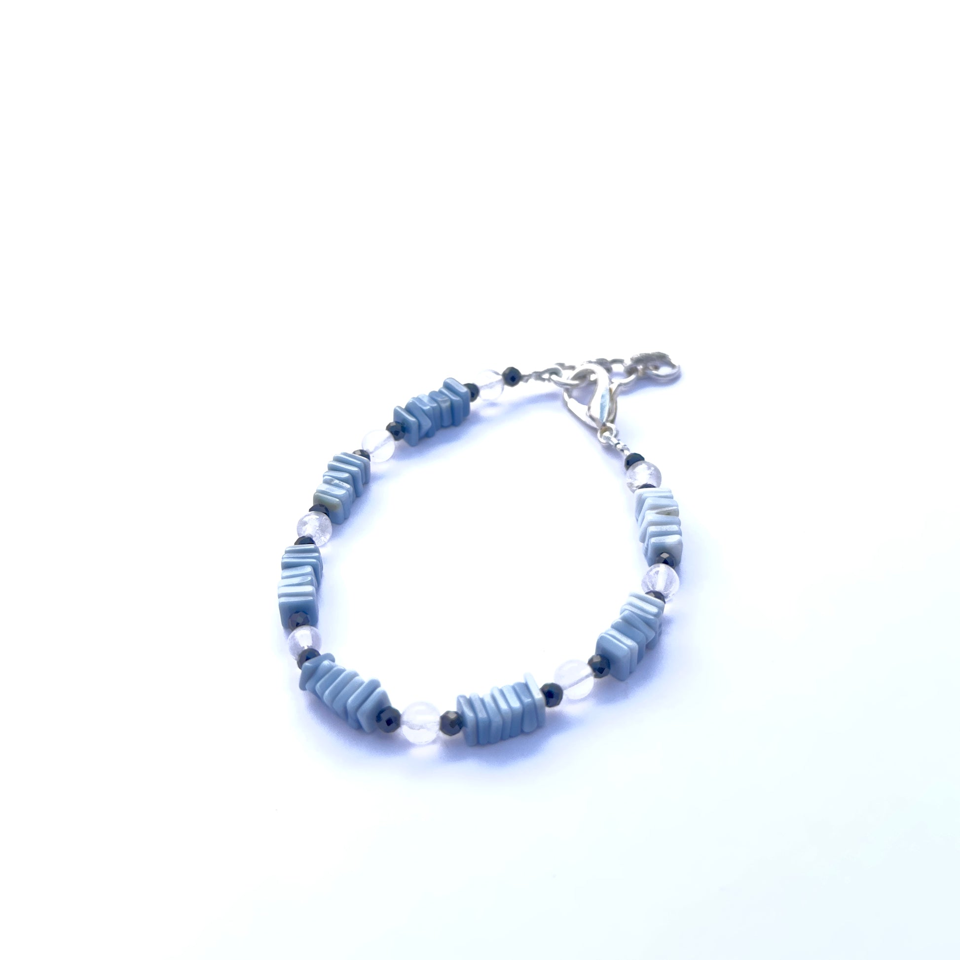 Natural gemstone beads in denim opal and crystal, arranged in a sleek adjustable bracelet.