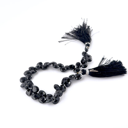 Black Spinel faceted briolette gemstones with glossy surfaces and crisp faceting in a uniform 7.5–8mm size range.