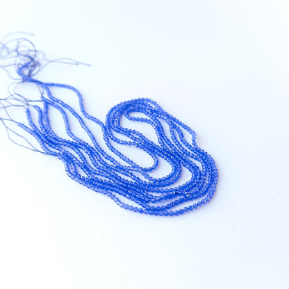 Close‑up of genuine Blue Chalcedony faceted rondelle beads showing their shine, clarity, and delicate 2.1mm cut.