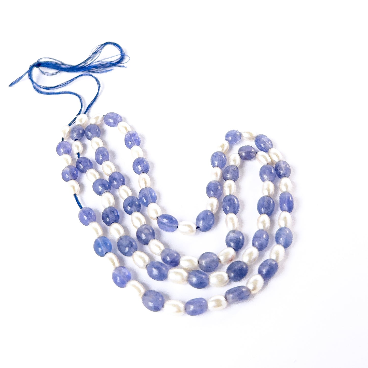 Premium Blue Quartz and Shell Pearl beads showcasing polished shine and elegant smooth oval shapes.