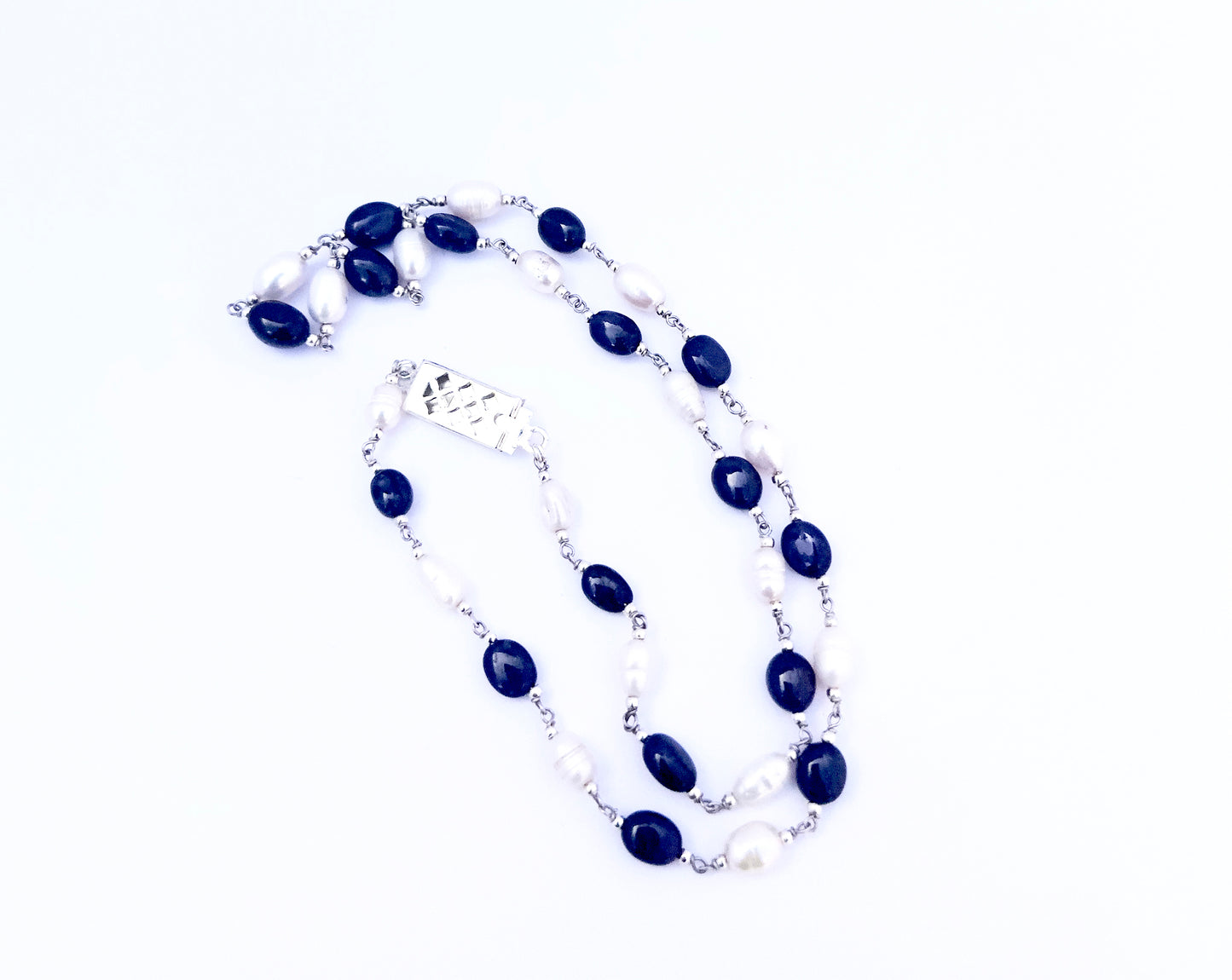 Elegant two‑strand sapphire and freshwater pearl necklace showcasing smooth oval beads.
