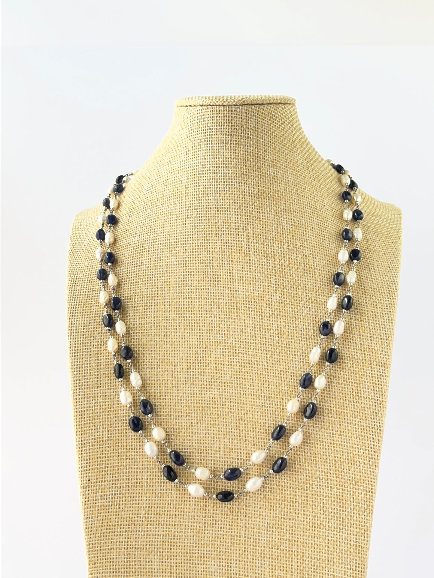 Two‑strand necklace featuring smooth oval blue sapphire and freshwater pearl beads sized 6–6.5mm.