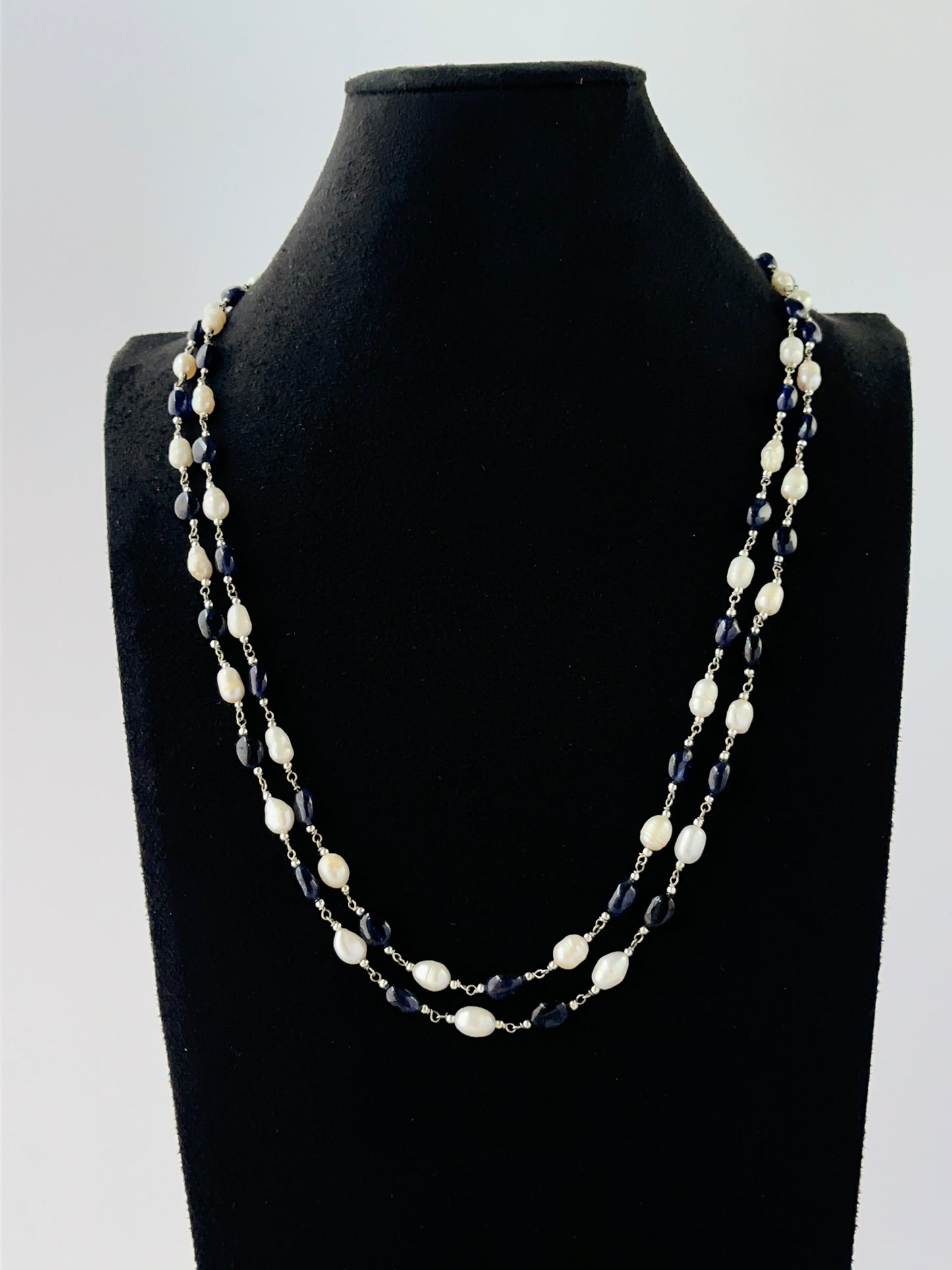 Multi‑strand sapphire and pearl necklace arranged with 6–6.5mm smooth oval beads.