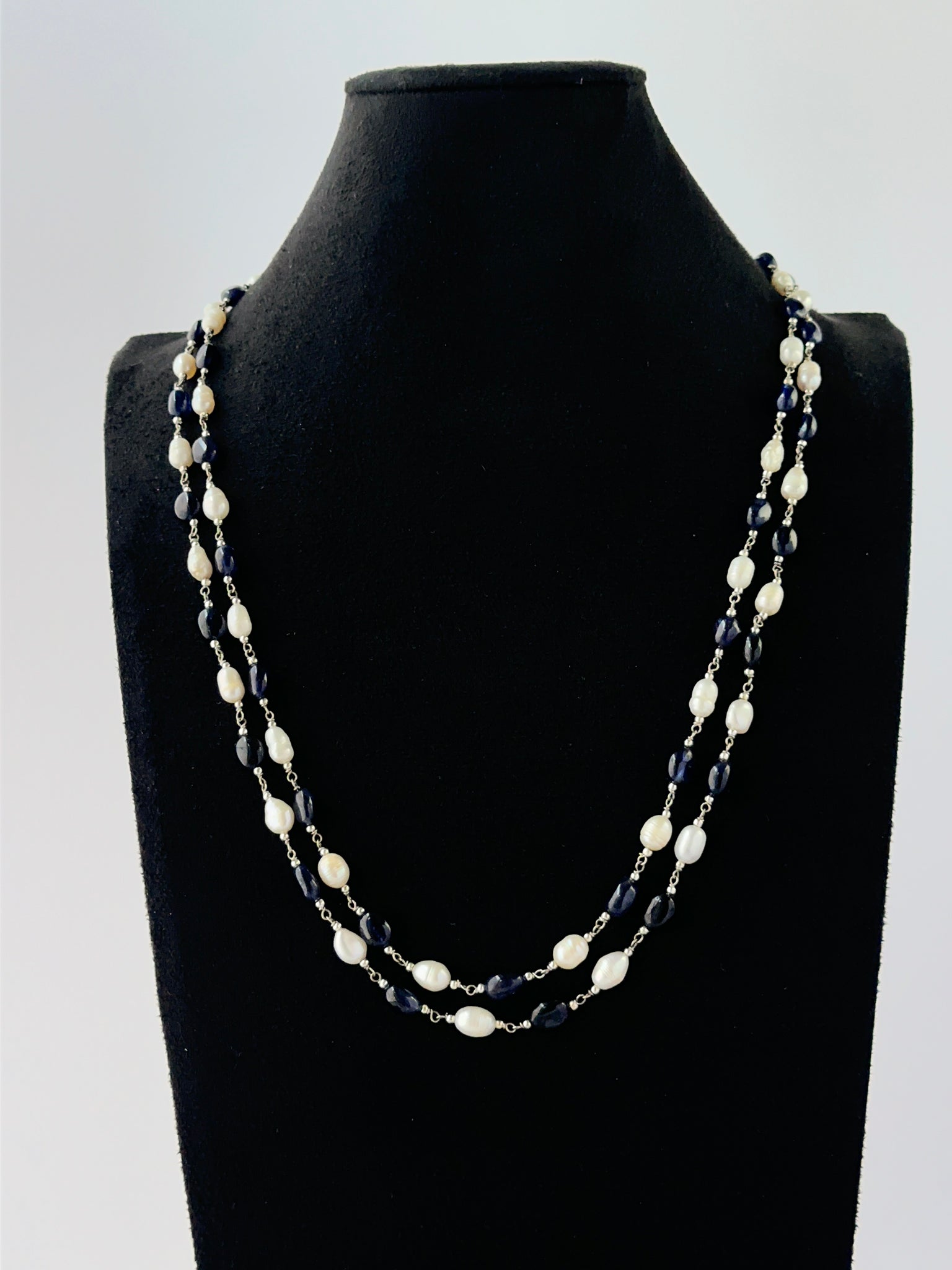 Multi‑strand sapphire and pearl necklace arranged with 6–6.5mm smooth oval beads.