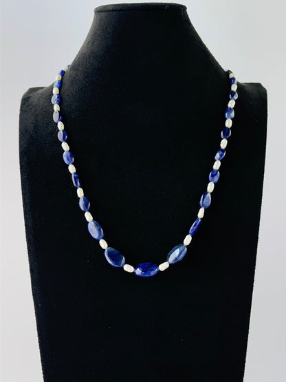 Blue sapphire and freshwater pearl necklace showcasing smooth oval beads in a single strand.