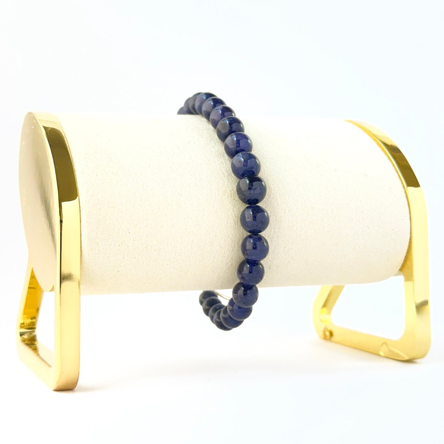 Blue sapphire bracelet featuring smooth round 5.5–7.3mm beads in a 16cm adjustable design.