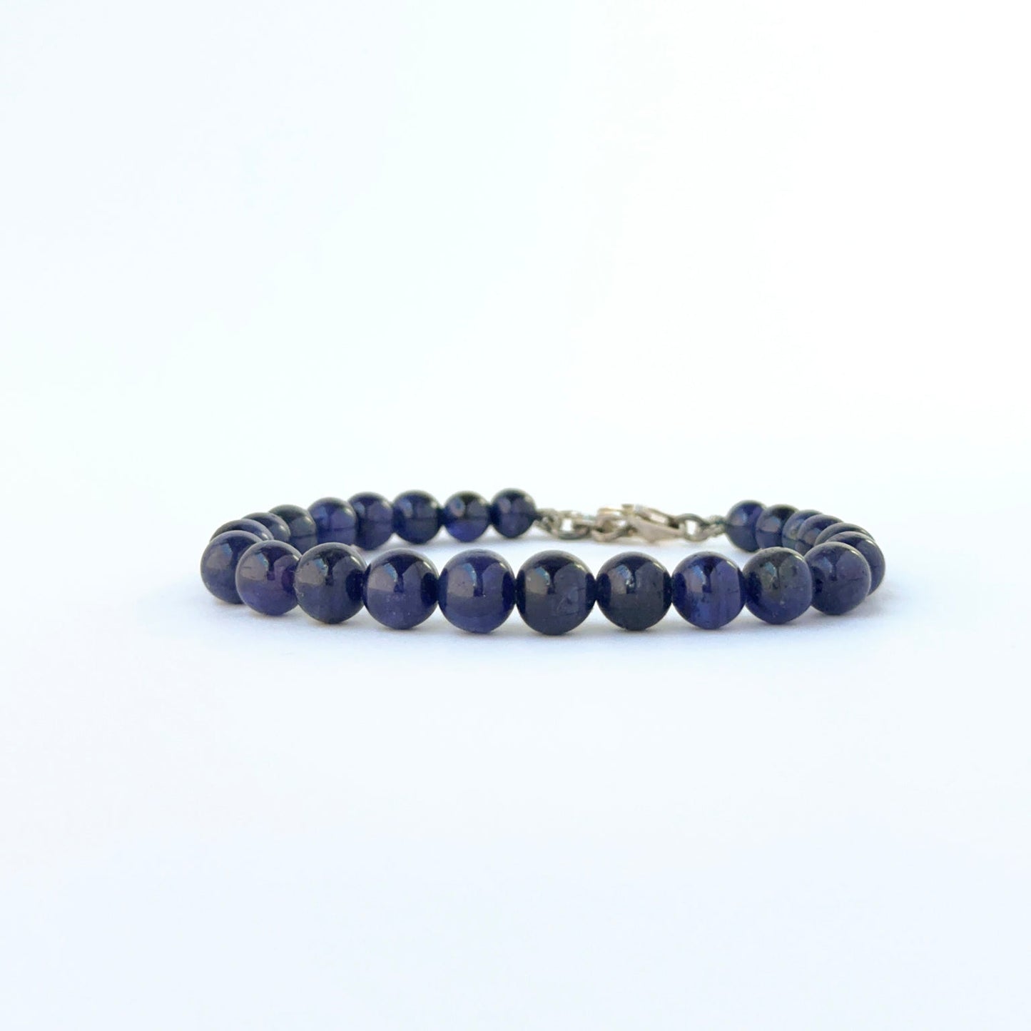 Smooth round sapphire bracelet showcasing 5.5–7.3mm beads with adjustable fit.