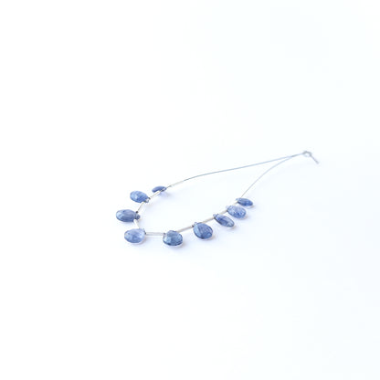 Close‑up of genuine Blue Sapphire faceted briolette beads showing sparkling facets and natural gemstone clarity.