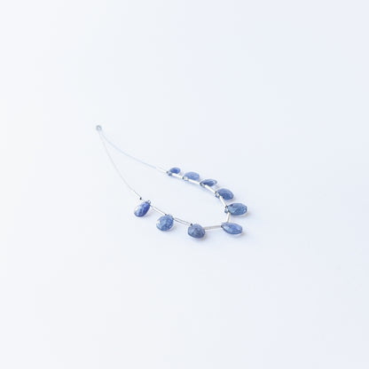 Handmade jewellery components featuring sparkling Blue Sapphire briolette beads in a neatly arranged set.