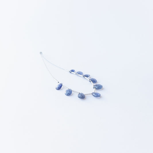 Handmade jewellery components featuring sparkling Blue Sapphire briolette beads in a neatly arranged set.