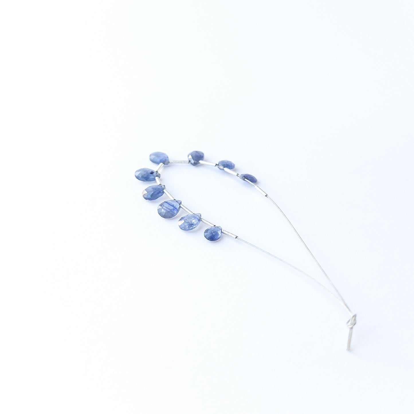 Blue Sapphire briolette beads showcasing natural shine and elegant teardrop faceting for gemstone creators.