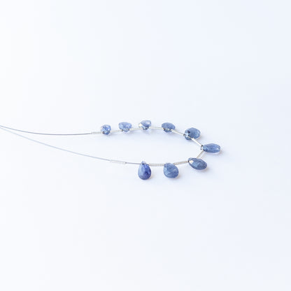 Blue Sapphire faceted briolette gemstone beads arranged in a deep blue strand for handmade jewellery making.