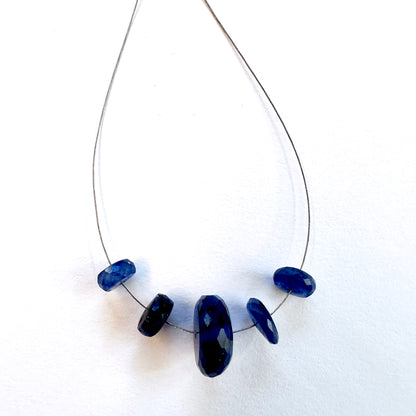 Close-up of Blue Sapphire faceted rondelle beads, 7.5-14mm, showcasing brilliance and precision cut for DIY jewellery.