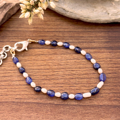 Blue sapphire and freshwater pearl bracelet featuring smooth oval beads.