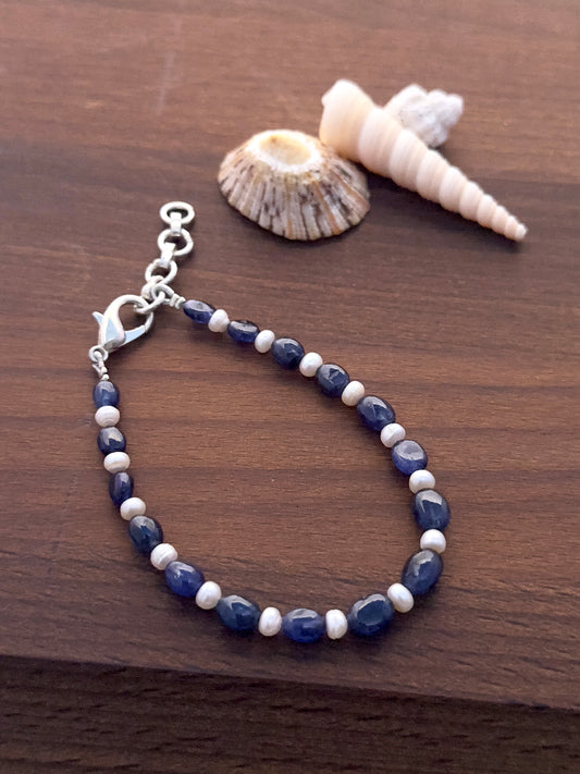 Blue sapphire and freshwater pearl bracelet with 5.6mm smooth oval beads and adjustable lobster clasp.