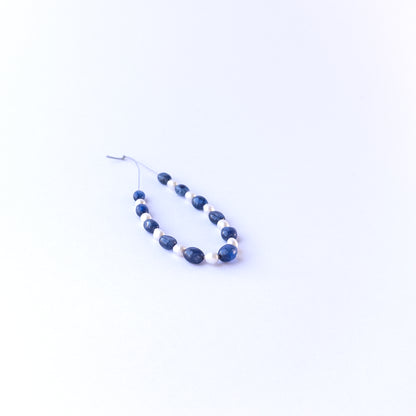 Strand of sapphire and freshwater pearl ovals displaying deep blue tones and soft pearl sheen for gemstone beads for DIY jewellery.
