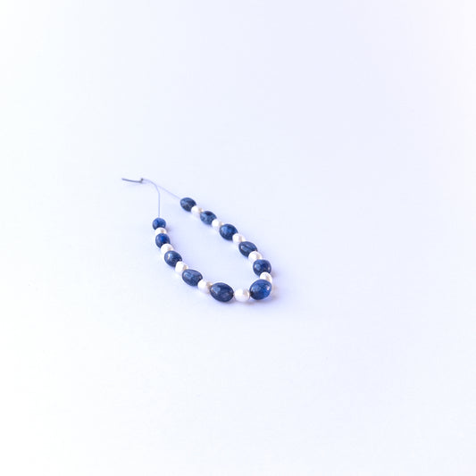 Strand of sapphire and freshwater pearl ovals displaying deep blue tones and soft pearl sheen for gemstone beads for DIY jewellery.