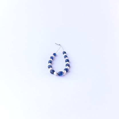 Detailed view of smooth oval sapphire and pearl beads with clean polish and elegant colour contrast for handmade jewellery components.