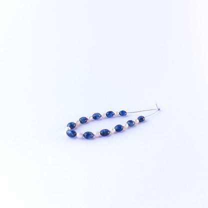 Mixed sapphire and freshwater pearl oval beads showing natural texture and quality for genuine gemstone bead crafting.