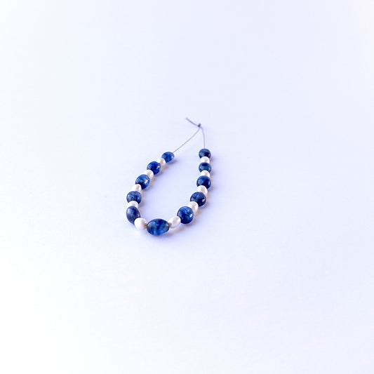Authentic sapphire and pearl stone beads in smooth oval cuts showing polished finish for jewellery design work.