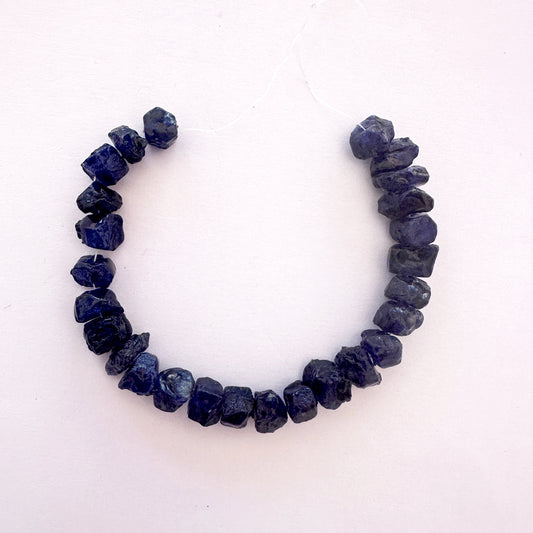 Blue sapphire rough beads with deep blue tones and centre-drilled 8.2–9.5mm size.