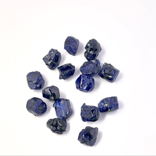 Close view of Blue Sapphire rough pieces arranged together, highlighting rich colour and handmade jewellery component quality.