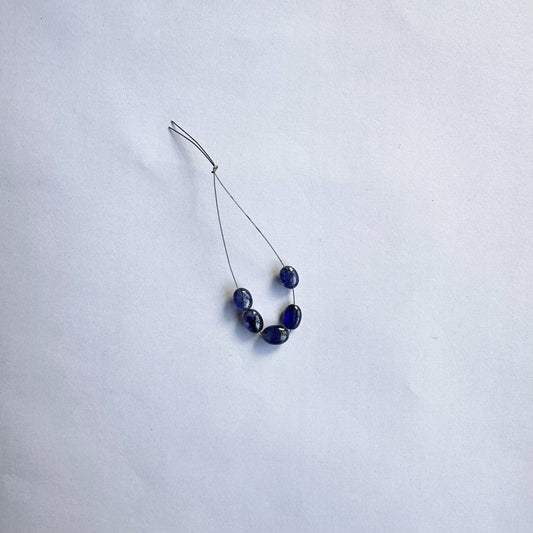 Blue Sapphire smooth oval beads gleam with rich colour and a flawless polish, arranged neatly in a set of five.