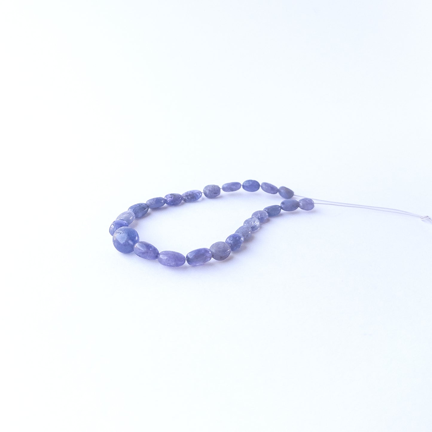 Blue Sapphire smooth oval beads displaying natural colour variation and premium craftsmanship.
