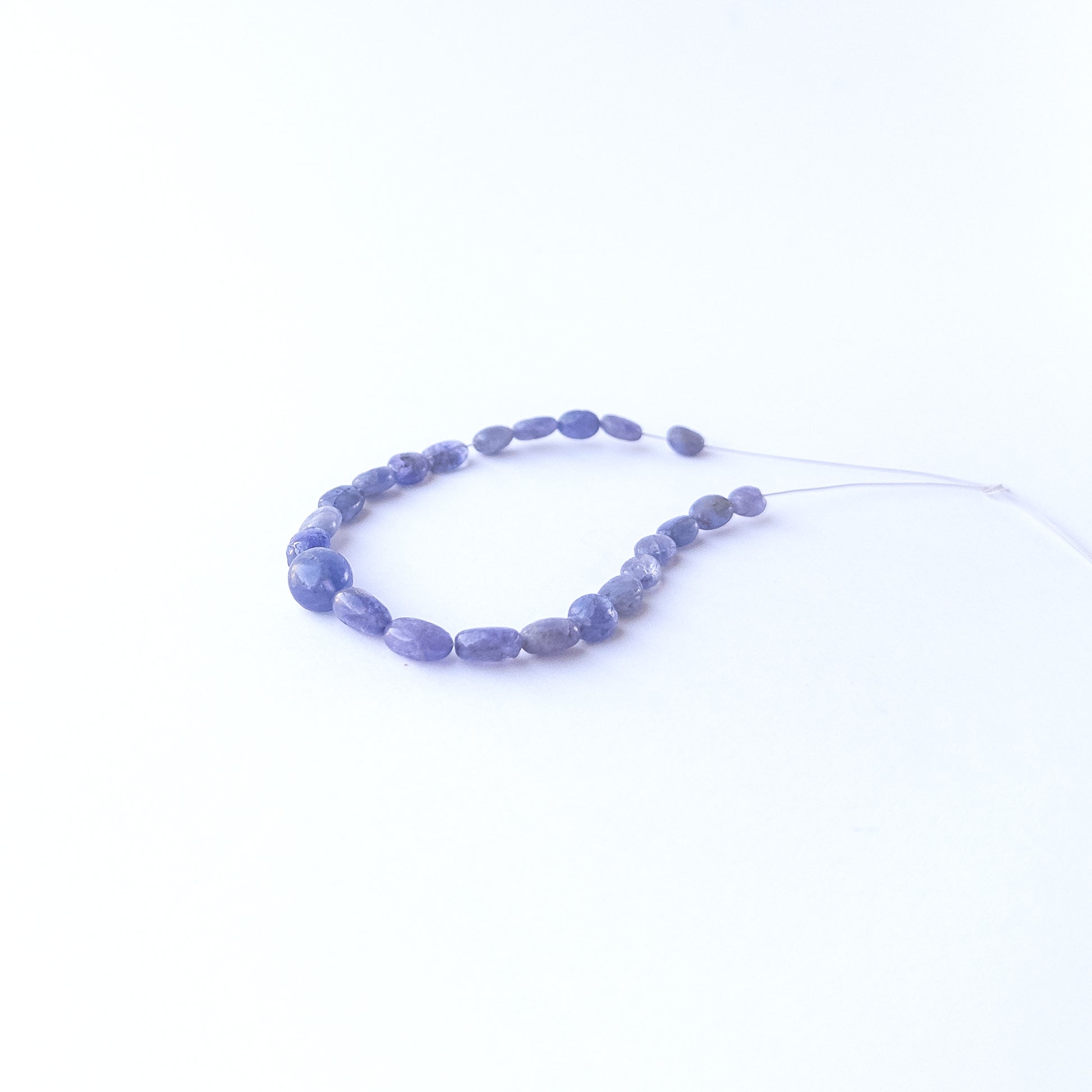 Blue Sapphire oval beads showcasing natural shine and elegant shape for gemstone bead creators.
