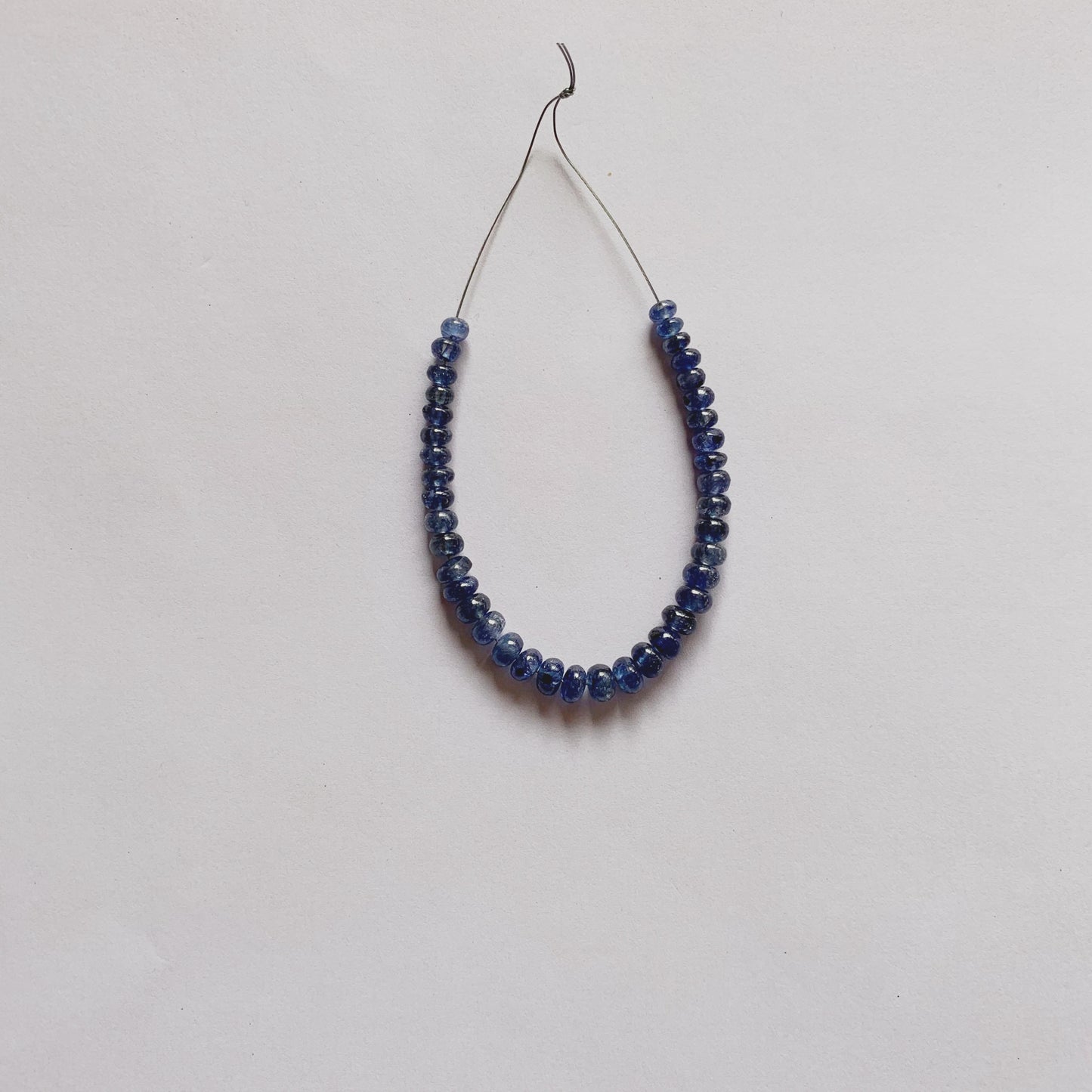 Blue Sapphire rondelle beads in rich blue tones, 3.8–5.2mm size, arranged in a unique 39-piece set.