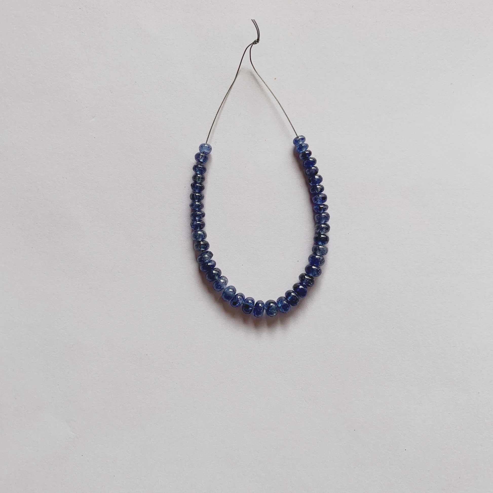 Blue Sapphire rondelle beads in rich blue tones, 3.8–5.2mm size, arranged in a unique 39-piece set.