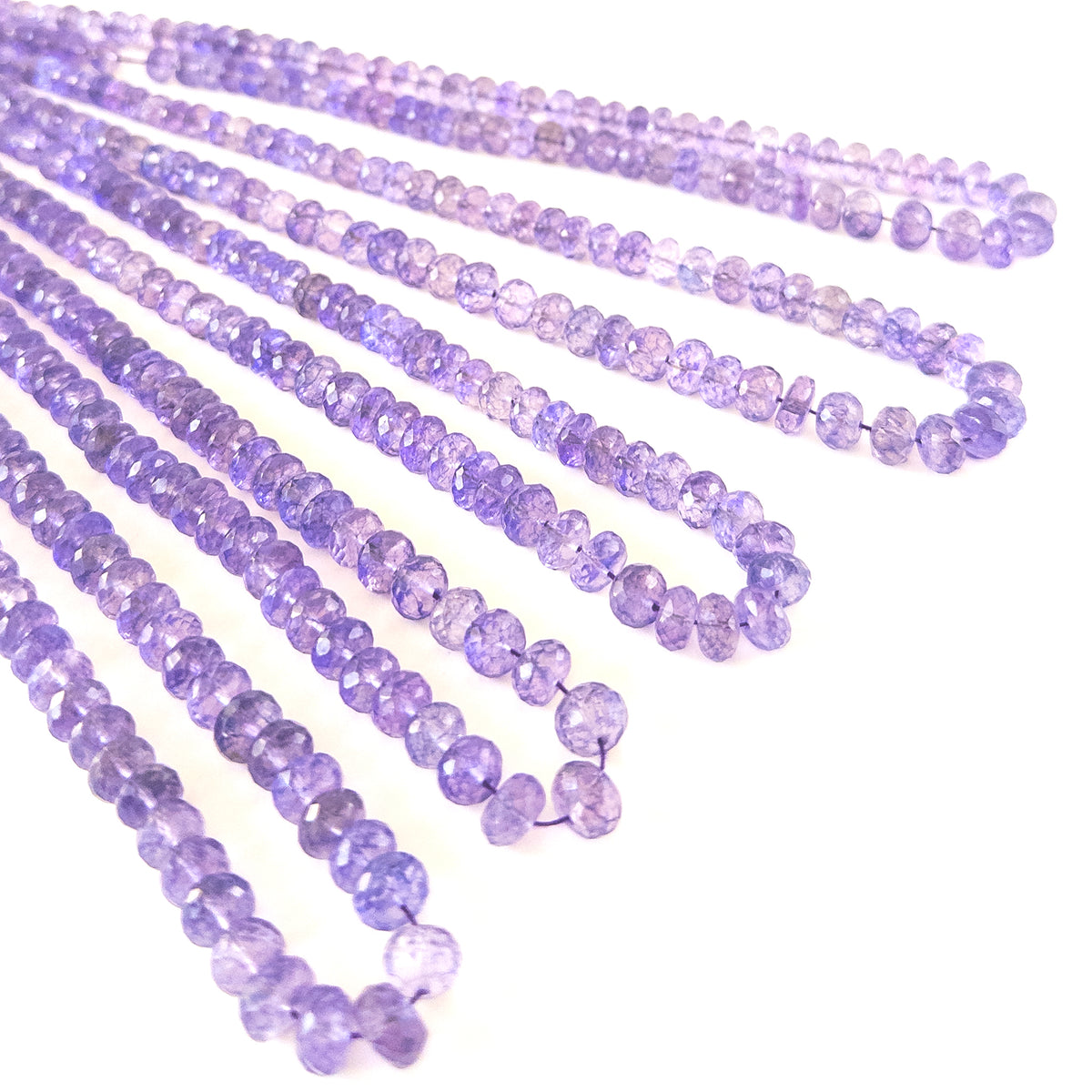Genuine Amethyst stone beads with micro‑faceted sparkle arranged in a uniform rondelle layout for handmade jewellery components.