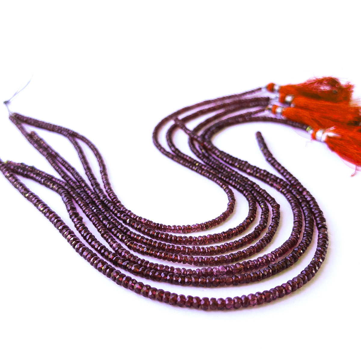 Authentic Burma Garnet gemstone beads displaying polished facets and natural red clarity.