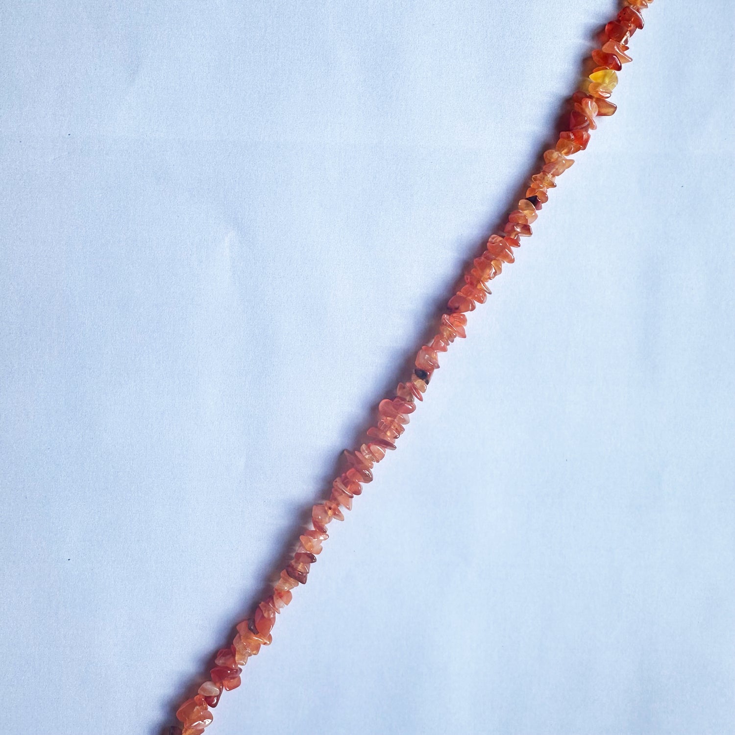 Carnelian chip beads radiate deep orange and red tones, arranged beautifully on a 44cm strand.